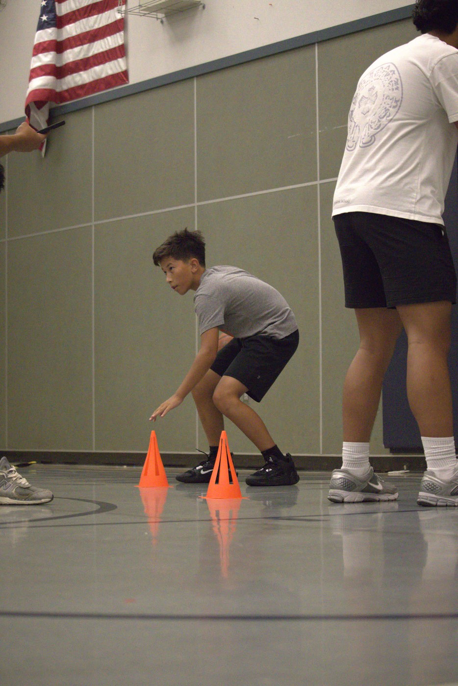 Athlete dribbling in defensive stance during training