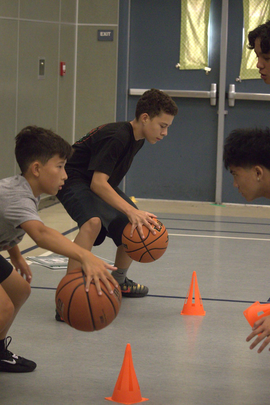 Coach working with athletes on ball-handling fundamentals