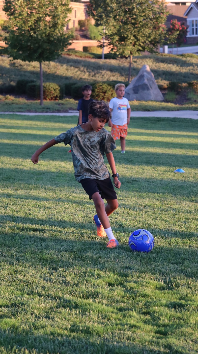 Young athlete kicking a soccer ball during a training drill
